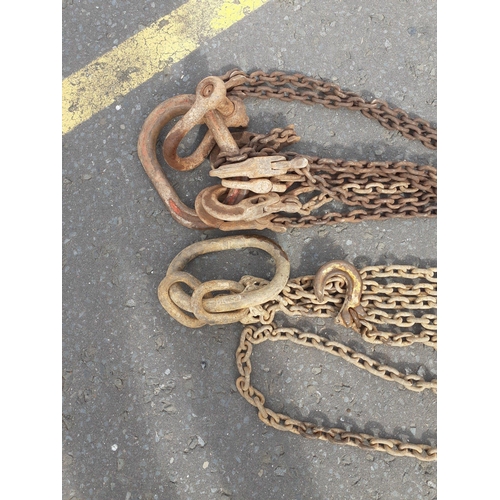 415 - Two sets of solid iron 'lifting chains' - 2.8m length one length approx with shackle - the other len... 