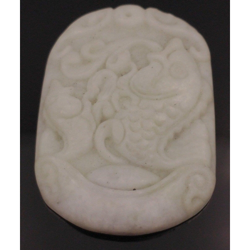 54 - Two carved jade pendants one 4cm long, the other, carved with fish is 5cm long#65