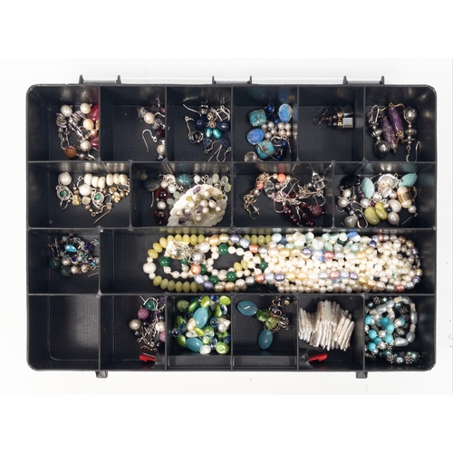 58 - A large collection within a compartment storage box to include strings of real pearls, some coloured... 