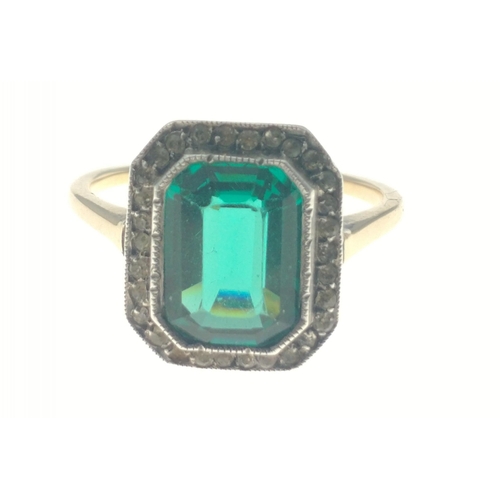 6 - A BOBBY DAZZLER - An indistinct stamp mark on yellow metal with large emerald style stone centred di... 