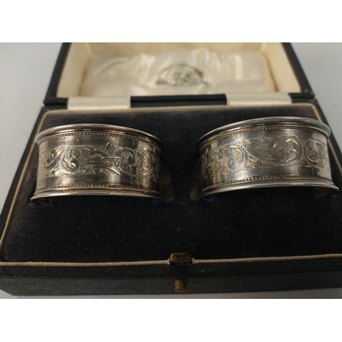 69 - A boxed pair of silver hallmarked napkin rings Newcastle 1915 weight 20.75g plus a further napkin ri... 