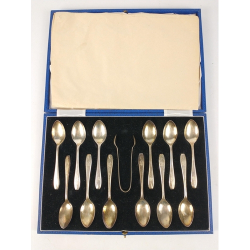 72 - A boxed set of 12 monogrammed silver teaspoons and pair of tongs, hallmarked Sheffield 1932, by Vine... 