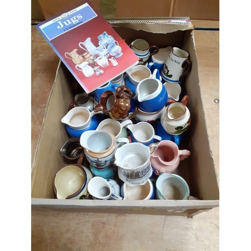 100 - A large collection of souvenir cream jugs from various locations around the UK including from Delft,... 