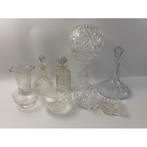 123 - A collection of crystal glass ware pieces to include a substantial lamp with globe. three decanters ... 