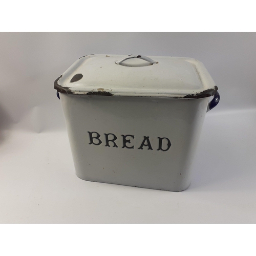 133 - A vintage enamel Bread Bin with cover.  Nice graphic to front and nice blue enamel handles. Wear and... 