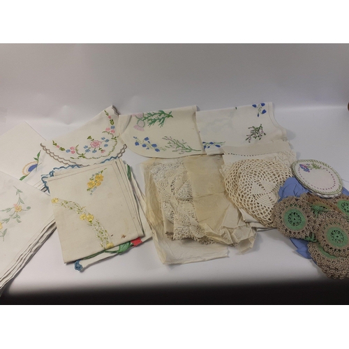 137 - A bag containing an interesting lot of embroidered table linen.  Large cloths appear to be hand sewn... 