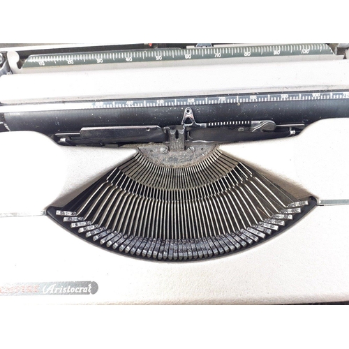 156 - EMPIRE ARISTOCRAT typewriter contained within its own metal removeabe cover.  A neat little item.  M... 