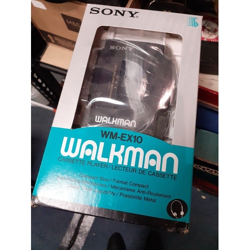 166 - A mixed lot of bric-a-brac to include a boxed Sony Walkman tape player, two brass jam thermometers, ... 