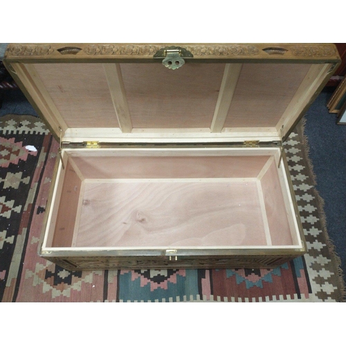 379 - An attractive large oriental themed blanket box with lovely decoration and superb carved panels.  Me... 