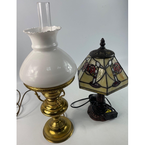 74 - Two reproduction lamps to include a brass lamp with milk glass shade (damage to shade) and a TIFFANY... 