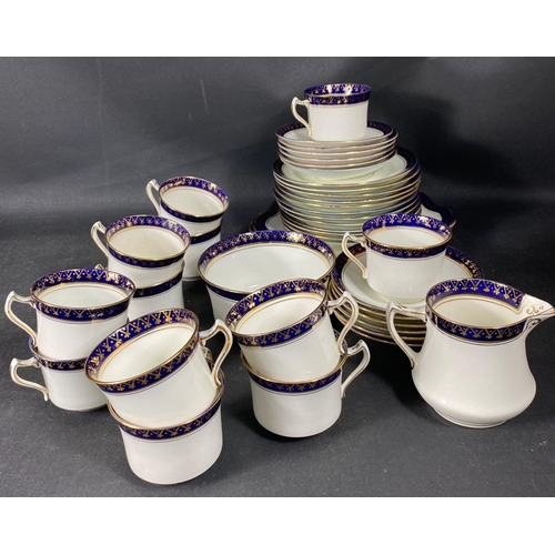 9 - A DIAMOND china tea service with a navy and gilt trim to include 12 cups, 12 saucers, 12 plates (17c... 