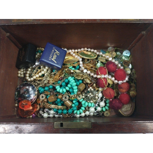 109 - A VINTAGE mahogany wooden jewellery box complete with key and contents, mainly strings of beads and ... 