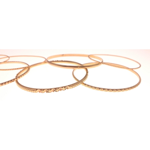 27 - Seven chased gold bracelets (independent jeweller tested 18ct), outer dia 6.5cm approx, weight 62.80... 