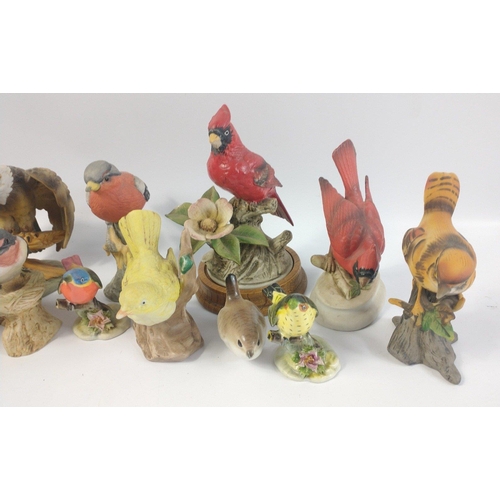 275 - A collection of THIRTEEN ceramic birds by various makers, the models include a roadrunner, bald eagl... 