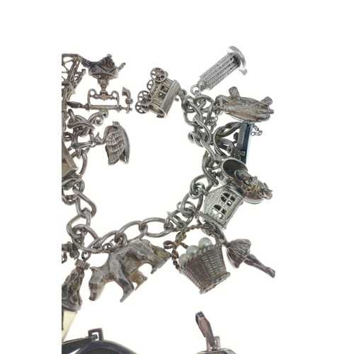 55 - First times a charm !  A lovely sterling silver charm bracelet.  Links are stamped 0.925 and charms ... 