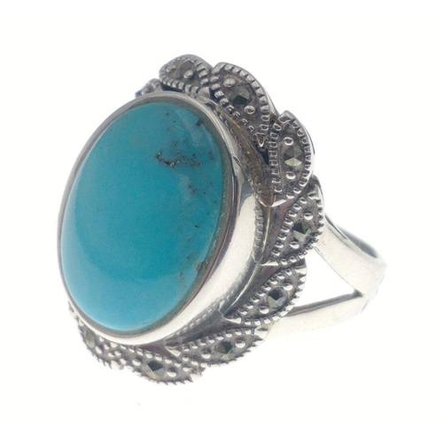 79 - A silver ring, stamped 925, with turquoise coloured stone (2cm), surrounded by marcasite, Size P, gr... 