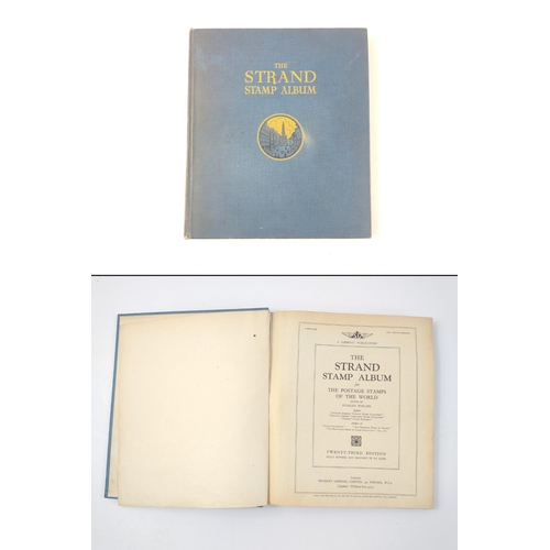 230 - A vintage 23rd edition STRAND STAMP ALBUM dated 1907 with several stamps contained inside from count... 