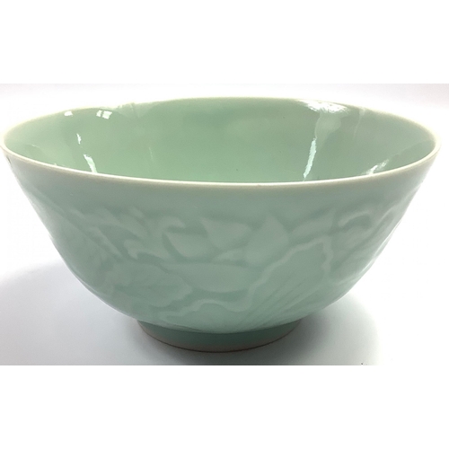 255 - A Chinese celadon bowl (15cm dia) with an embossed design of carp, with four characters signature to... 