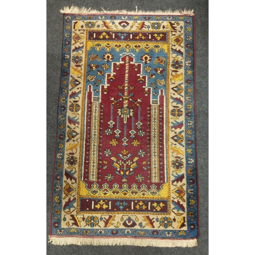 270 - A woollen prayer rug from Turkey in shades of red, blue and yellow 130x80cm#270