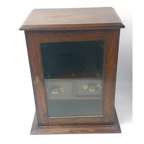 278 - An cEDWARDIAN Oak SMOKERS CABINET with a glazed door fitted with a working lock and key , ideal for ... 