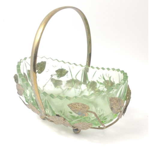 280 - A VINTAGE! GREEN GLASS dish in a metal holder with leaf design on four ball feet , 18cm long and sta... 