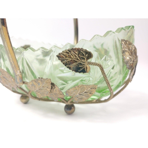 280 - A VINTAGE! GREEN GLASS dish in a metal holder with leaf design on four ball feet , 18cm long and sta... 