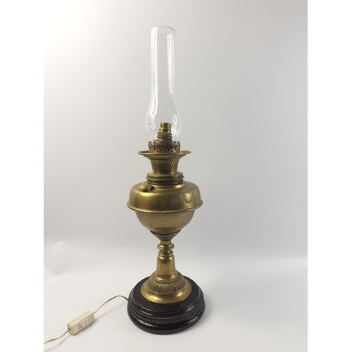 338 - A heavy converted brass oil lamp standing 62cm tall including the funnel. Could do with a sympatheti... 