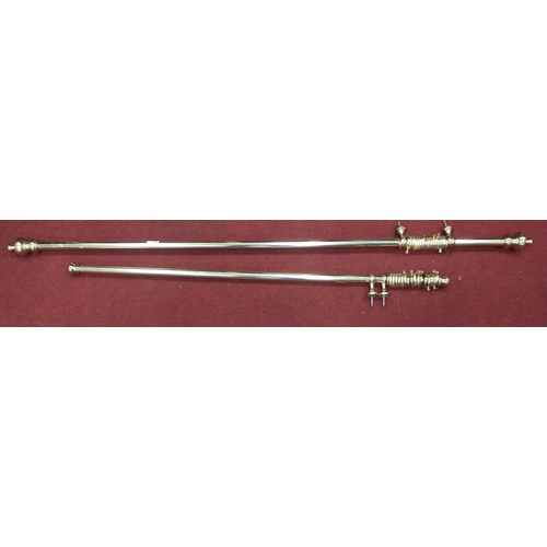 388 - Two brass CURTAIN POLES complete with wall mounts and curtain rings , the smaller pole measures 124c... 