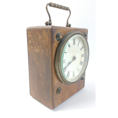 145 - An antique wooden cased travel clock with brass carry handle.  Brass mechanism does not have a maker... 