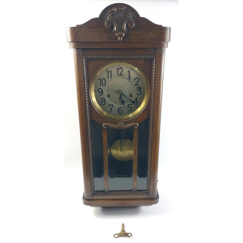 147 - A large oak cased WALL CLOCK the case measures 80cm x 32cm x 17cm#147