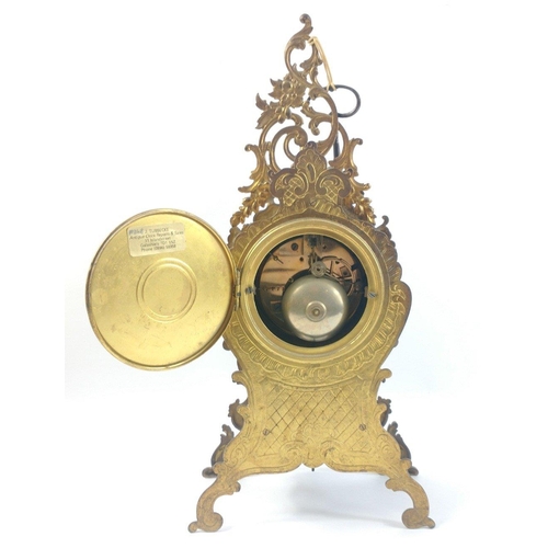 150 - A highly decorative continental MANTLE CLOCK in a brass scrolling case with applied painted scenes ,... 