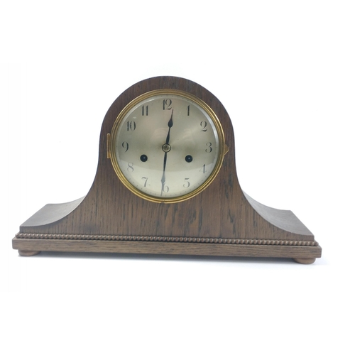 152 - A wooden cased mantle clock. German stamp to brass mechanism, complete with key.  Appears to be work... 