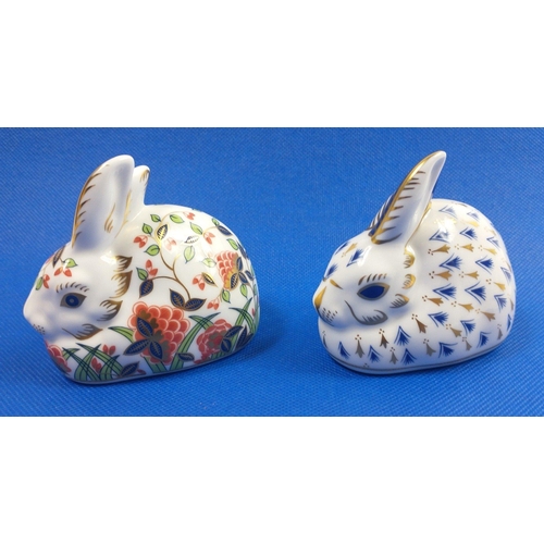 249 - Two ROYAL CROWN DERBY rabbit paperweights both with gold stopper, one in blue and white with gilt ac... 