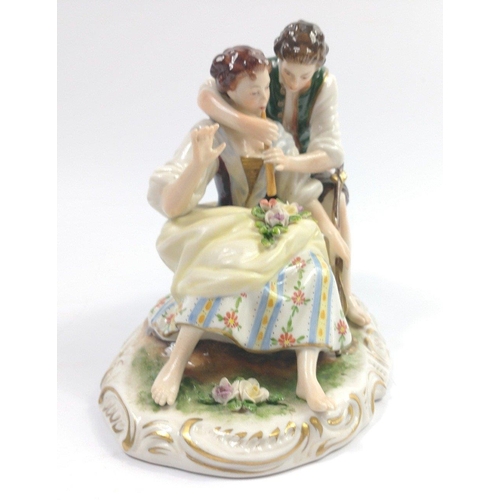 281 - An East German figurine of a young man and girl playing the flute, made mid 20th century by Rudolf K... 