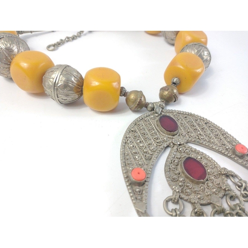 33 - Large and impressive Middle Eastern faux amber and white metal necklace with attached bells. 48cm ac... 