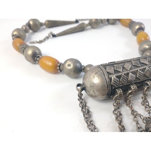 34 - Middle Eastern faux amber and white metal necklace with barrel style pendant and attached bells. Ano... 