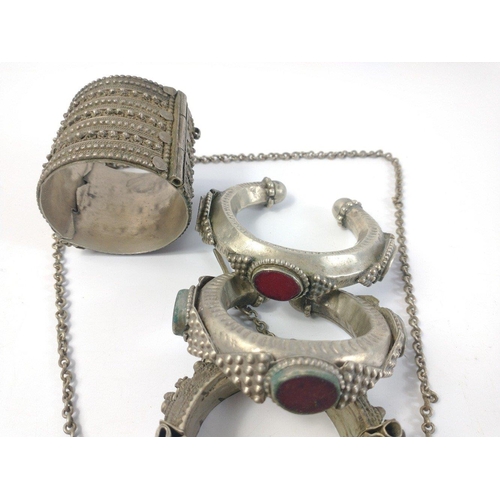 45 - A small collection of white metal Middle Eastern jewellery items comprising of two torques, two slav... 