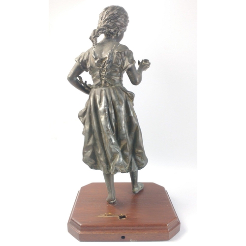 651 - A spelter figure of a young girl with fruit, standing an impressive 47cm tall approx and in generall... 