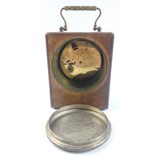 145 - An antique wooden cased travel clock with brass carry handle.  Brass mechanism does not have a maker... 