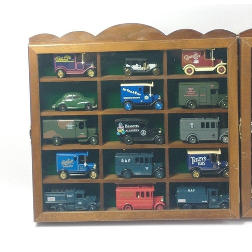 339 - Two small wall mounted display cases each with 15 toy trucks by various makers including LLEDO , DAY... 