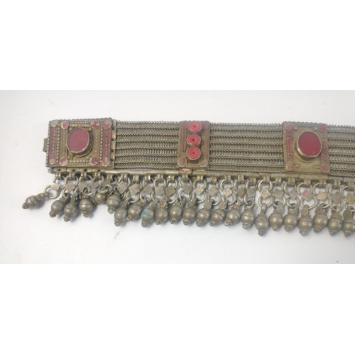 37 - A vintage Middle Eastern belt in white metal hung with bells. A very hefty piece weighing in at  ove... 