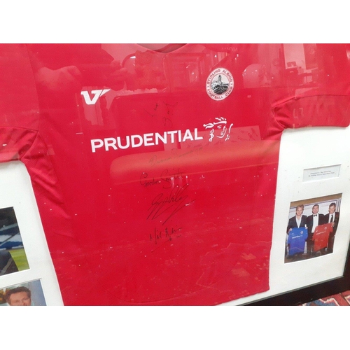 503 - A framed signed STIRLING ALBION football club shirt, signatories include Duncan Bannatyne, etc, alon... 