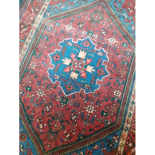 549 - Large Persian rug red base with blue central medallion and floral decoration. A very attractive piec... 