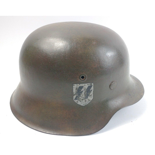 137 - WWII M40 German military helmet with later chin strap and applied SS decal.  There is a stamp '1937'... 