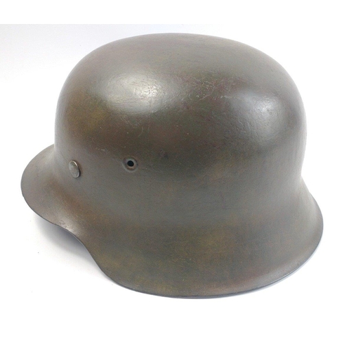 137 - WWII M40 German military helmet with later chin strap and applied SS decal.  There is a stamp '1937'... 