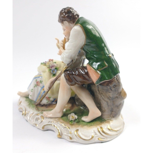 186 - An ANTIQUE East German figurine of a young man and girl playing the flute, made mid 20th century by ... 