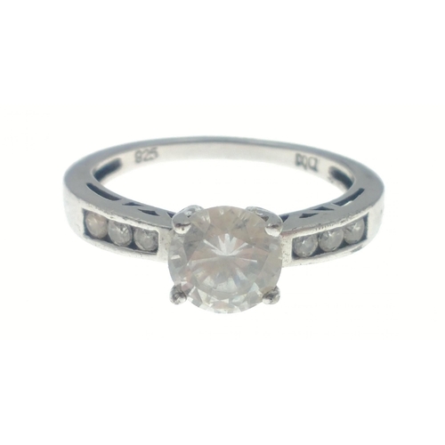 26 - A silver 925 stamped dress ring with a large white cubic zirconium stone centred(dimensions 6mm diam... 