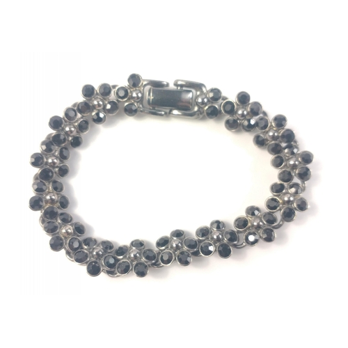 43 - A black-jet floral form white metal bracelet with safety chain, and comes within a nice presentation... 