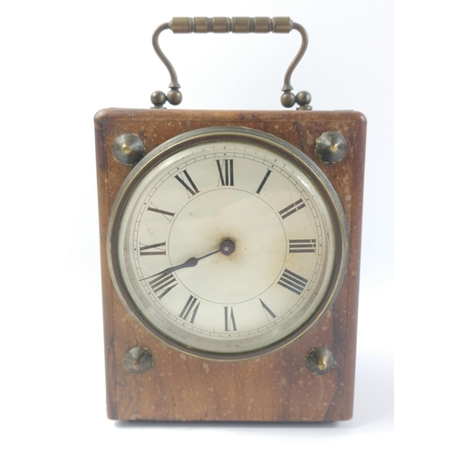 71 - An antique wooden cased travel clock with brass carry handle.  Brass mechanism does not have a maker... 