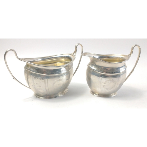 79 - A hallmarked silver, Birmingham 1919, milk jug and sugar bowl by ELKINGTON with laurel wreath decora... 